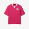 Polo oversize en satin rehaussé d’un badge Runway Polo oversize en satin rehaussé d’un badge Runway