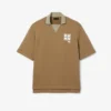 Polo oversize en satin rehaussé d’un badge Runway Polo oversize en satin rehaussé d’un badge Runway