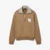 Sweats à col montant et fermeture éclair avec badge, inspirés des défilés